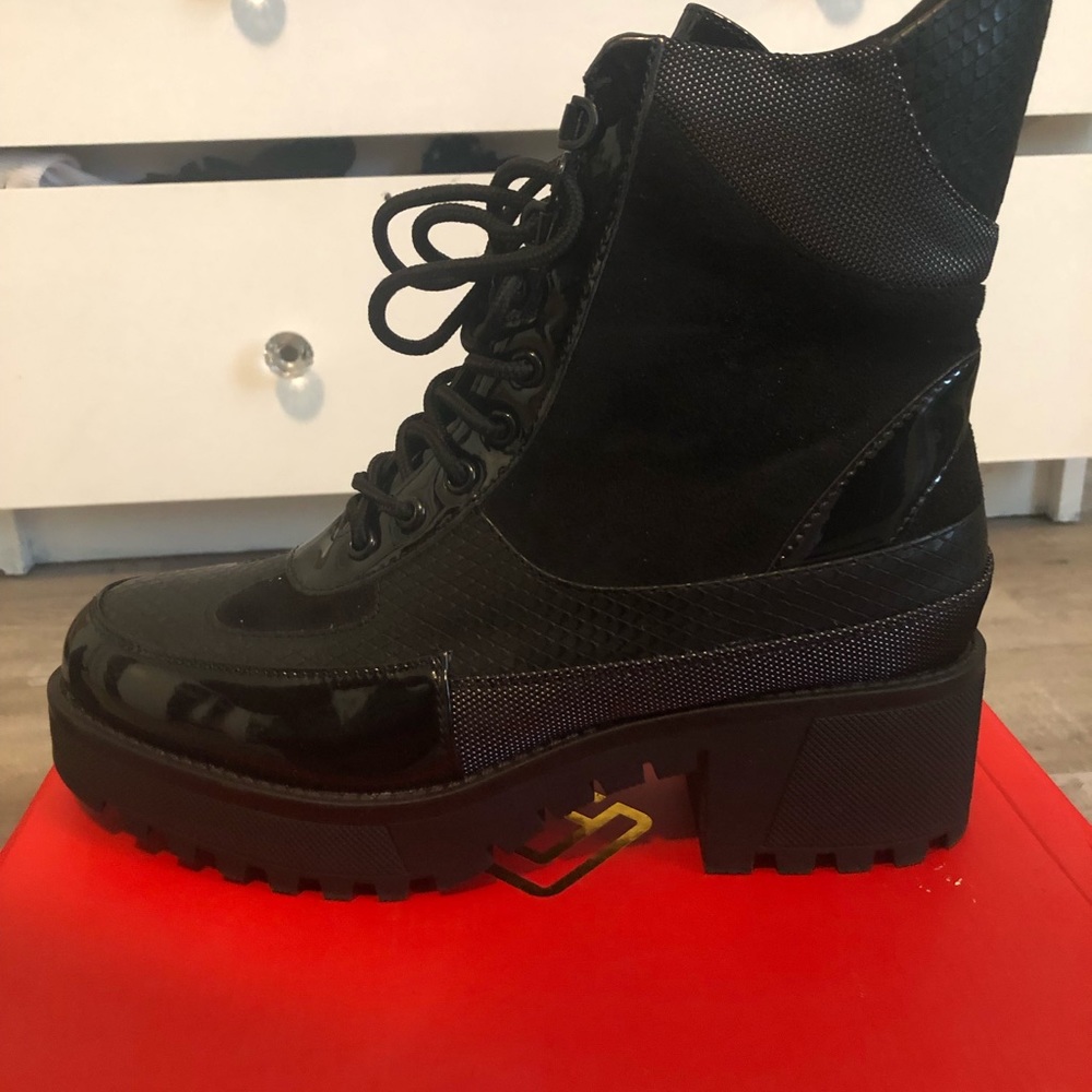 Combat boots- patent leather and snake skin pattern.